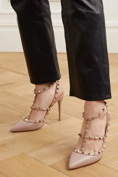 Best reserved for special occasions, Valentino Garavani's iconic 'Rockstud' pumps have been crafted in Italy from blush leather and embellished with signature studs. The gold adornments are hand-galvanized one by one for a lustrous finish that won't tarnish. They're set on high 100mm heels, but the cushioned insoles ensure they're comfortable.  Shown here with: [RtA Pants id1200363], [The Row Sweater id1203678], [Loewe Tote id1150433], [Lauren Rubinski Necklace id1237627]. Valentino Studded Heels, Valentino Rockstud Heels, Valentino Rockstud Pumps, Rockstud Heels, Valentino Heels, Valentino Garavani Shoes, Elegant Sandals, Studded Heels, Valentino Rockstud