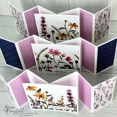 some cards with flowers on them are arranged in an origami style fold up