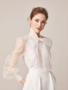 155 wedding separates with chiffon pussy bow bridal blouse above a sleek, simple a-line skirt. Mix and match with other separates for a flexible look. Available at Miss Bush UK Jesus Peiro stockist in Ripley, Surrey - 20 minutes from Central London.  #jesuspeiro #modern #bride #bridal #blouse #bow #pussybow #separates #chiffon #jpcala Wedding Gowns Satin, Bridal Wedding Gowns, Bridal Dresses Vintage, Jesus Peiro, Satin Wedding Gown, Bridal Separates, Makijaż Smokey Eye, Satin Long Sleeve, Ivory Bridal