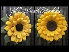 two yellow sunflowers with green leaves are on the side of a wooden fence