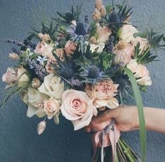 a person holding a bouquet of flowers in their hand