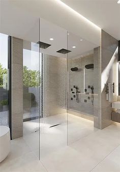 a modern bathroom with glass walls and white fixtures