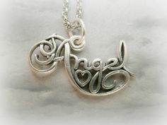 a silver necklace with the word hope written in cursive font