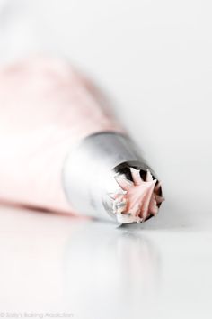 a close up view of the inside of a metal tube with pink flowers on it