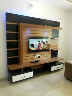 the entertainment center is built into the wall with shelving units and drawers on each side