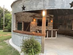 an outdoor bar made out of galvanized steel with stars hanging from the roof