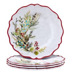 four plates with floral designs and red trimmings on each plate, all stacked together