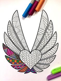 a coloring page with two markers and some pens on the table next to it is a drawing of a bird