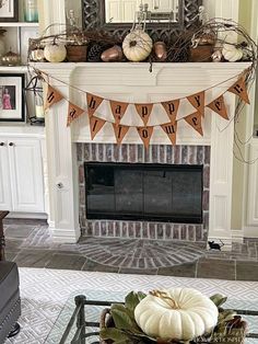 a living room decorated for halloween with pumpkins on the mantel and bunting