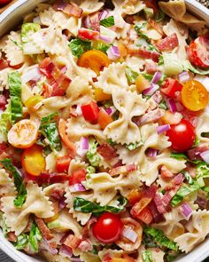 a bowl filled with pasta salad and tomatoes