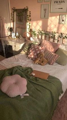 there is a bed with pillows on it and a teddy bear sitting on the pillow