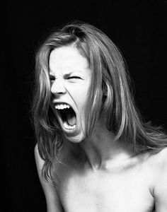 a shirtless woman with her mouth open