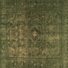 an old rug with green and gold colors on the carpet is shown in this image