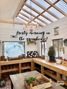 a room with wooden tables and potted plants on the table in front of it