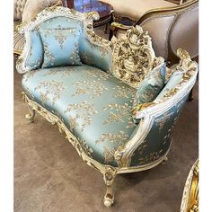 an ornately decorated chaise lounge in blue and gold