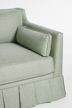 an upholstered chair with pleated cushions