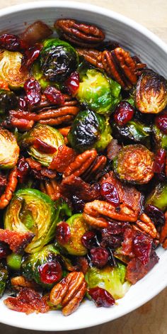 brussel sprouts with pecans and cranberries in a white bowl