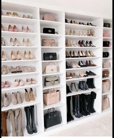 a white closet filled with lots of different types of shoes and purses on shelves