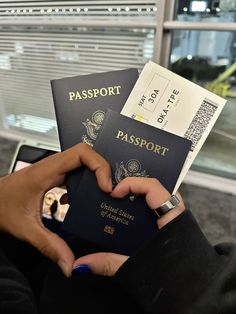 a person holding two passports in their hands