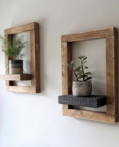 two square wooden shelves with plants on them