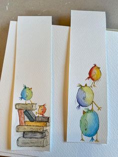 three watercolor paintings of children's books with birds sitting on top of them