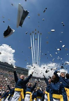 the graduates are throwing their caps in the air