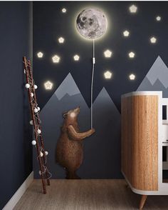 there is a bear that is playing with the moon in the night sky and it's lights are turned on