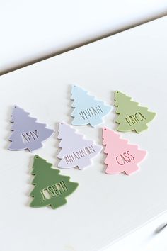 small wooden christmas trees with names on them