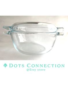 a glass bowl with two handles on the side