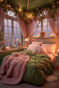 a bed with pink and green sheets in a room next to two large windows filled with candles