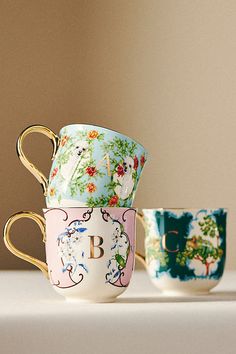 two coffee cups sitting next to each other on a table