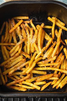 french fries are being cooked in a pan on the grill, ready to be eaten