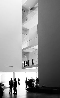 black and white photograph of people in an atrium