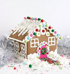 a gingerbread house is surrounded by confetti and sprinkles