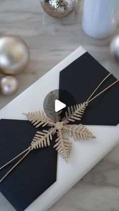 a white table topped with a black and gold snowflake