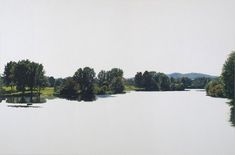 an image of a lake with trees in the background