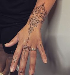 a woman's hand with tattoos on it