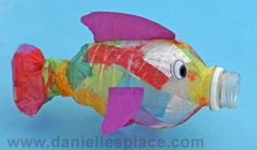 a fish made out of tissue paper sitting on top of a blue background with the words twisted water bottle fish craft