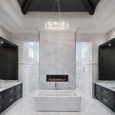 a large bathroom with two sinks and a fireplace