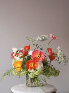 a vase filled with flowers sitting on top of a table