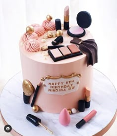 a birthday cake decorated with makeup and accessories