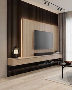 a living room with a large flat screen tv mounted on the side of it's wall