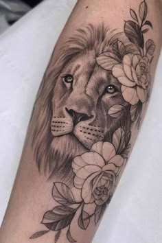 a lion with flowers on his arm