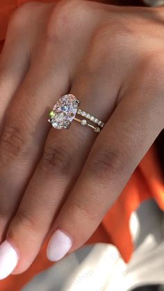 a woman's hand with a diamond ring on it