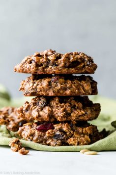 three cookies stacked on top of each other with cranberries and oatmeal