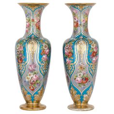 two vases with flowers painted on them are standing next to each other in front of a white background