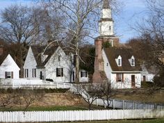 a white house with a clock tower in the background