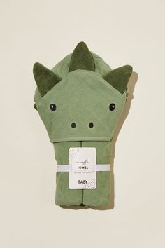 a green towel with an animal face on it's side and a tag hanging from the front