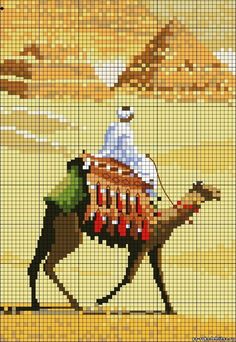 a man riding on the back of a camel across a desert