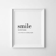 a black and white poster with the words smile in it's frame on a wall